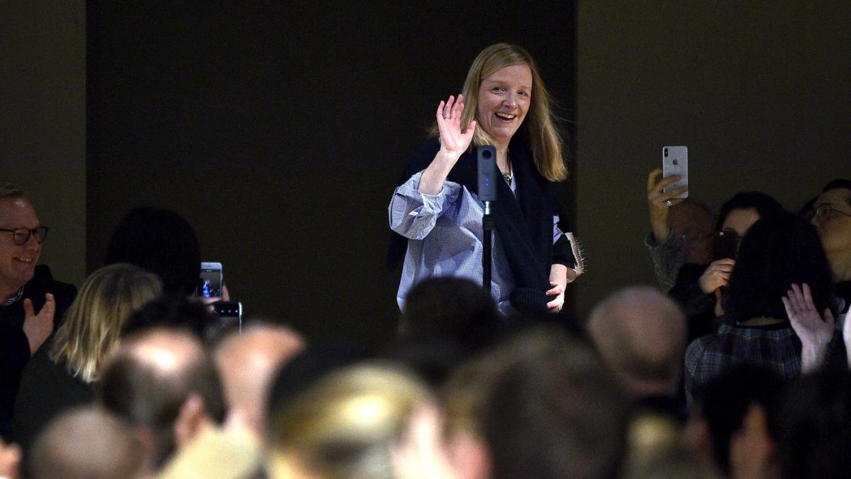 designer sarah burton waves to the crowd after an alexander mcqueen show