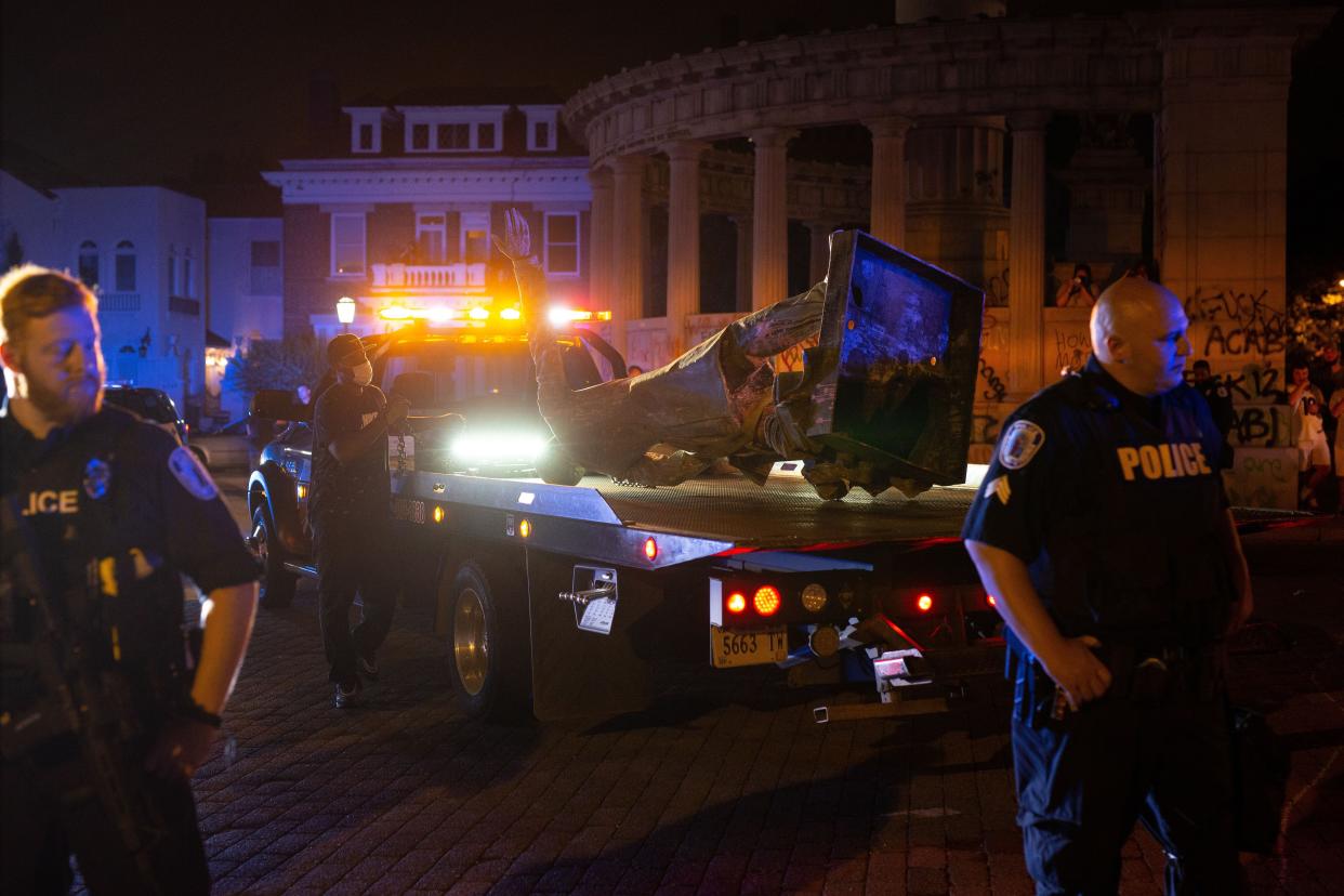 A statue of Confederate States President Jefferson Davis is loaded on a tow truck after protesters pulled it down in Richmond, Va on June 10, 2020.