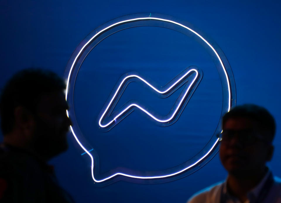 People converse in front of a logo of Facebook messenger, during a Meta event in Mumbai, India, 20 September, 2023. (Photo by Niharika Kulkarni/NurPhoto via Getty Images)