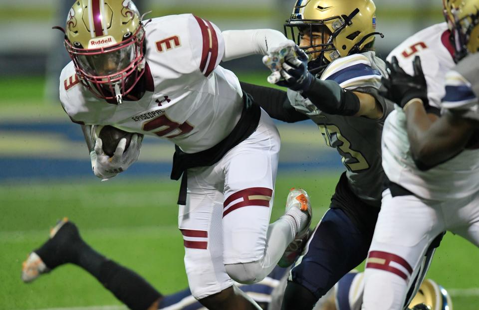 Episcopal's (3) Corey Scott scrambles from University Christian defenders on the opening kickoff of an Oct. 28 game.