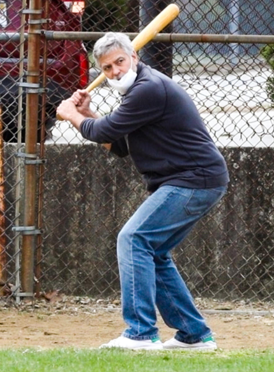 <p>George Clooney takes a few swings in between filming his upcoming film <em>The Tender Bar</em> on Wednesday in Boston.</p>