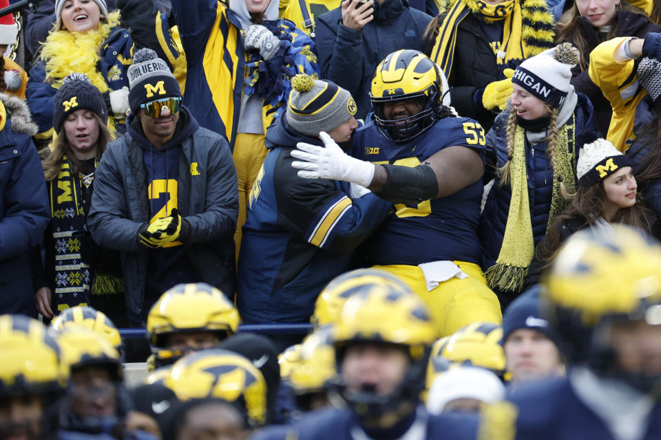 Nov. 19, 2022; Ann Arbor; Michigan Wolverines Players celebrate after the game against the Illinois Fighting Illini at Michigan Stadium. Rick Osentoski-USA TODAY Sports