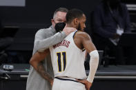 Denver Nuggets coach Michael Malone, left, talks with guard Monte Morris during the first half of an NBA basketball game against the Sacramento Kings in Sacramento, Calif., Saturday, Feb. 6, 2021. (AP Photo/Rich Pedroncelli)