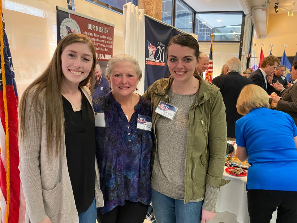 The family of Homes for our Troops recipient Staff Sgt. Michael Downing, from left, daughter Alexandra Keilty, wife Dawnalee Downing and daughter Samantha Bullock attend the Homes for Our Troops 20th anniversary celebration on Tuesday, Feb. 6, 2024 at the organization's Taunton headquarters.