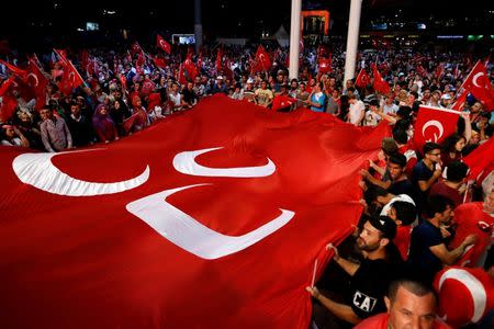 Supporters of Turkish President Tayyip Erdogan wave Turkish flags during a pro-government demonstration at Taksim square in central Istanbul, Turkey, July 20, 2016.REUTERS/Ammar Awad