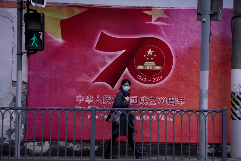 A woman wearing a face mask is seen on a street in Shanghai