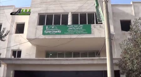 A sign is seen on the building of what is said to be a hospital damaged by missile attacks in Azaz, Aleppo, Syria, February 15, 2016 in this still image taken from a video on a social media website. REUTERS/Social Media Website via Reuters TV