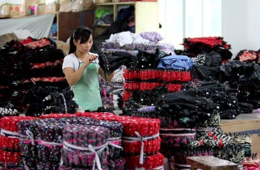 A woman works at an umbrella factory in Jinjiang, south China's Fujian province in April 2012. China's export-driven economy has begun to slow this year, with growth falling to 8.1 percent in the first quarter from 9.2 percent in 2011, as woes in key export markets such as Europe and the United States hit its overseas sales