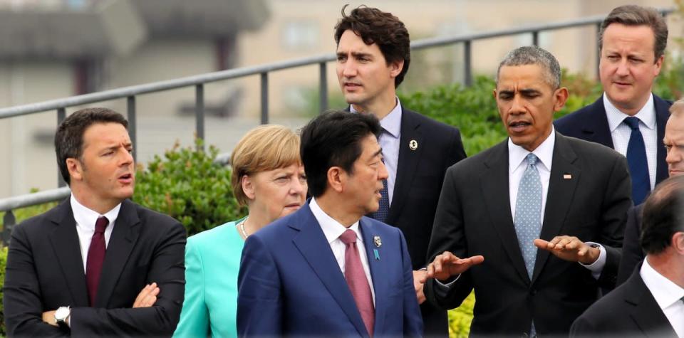 Japanese Prime Minister Shinzo Abe, center, chats with U.S. President Barack Obama, fifth left, as other leaders of Group of Seven industrial nations, from left, Italian Prime Minister Matteo Renzi, German Chancellor Angela Merkel, Abe, Canadian Prime Minister Justin Trudeau, top, Obama, British Prime Minister David Cameron and European Council President Donald Tusk, walk along for a family photo session on the first day of the G-7 summit meetings in Shima, Japan, Thursday, May 26, 2016. (Japan Pool via AP) 