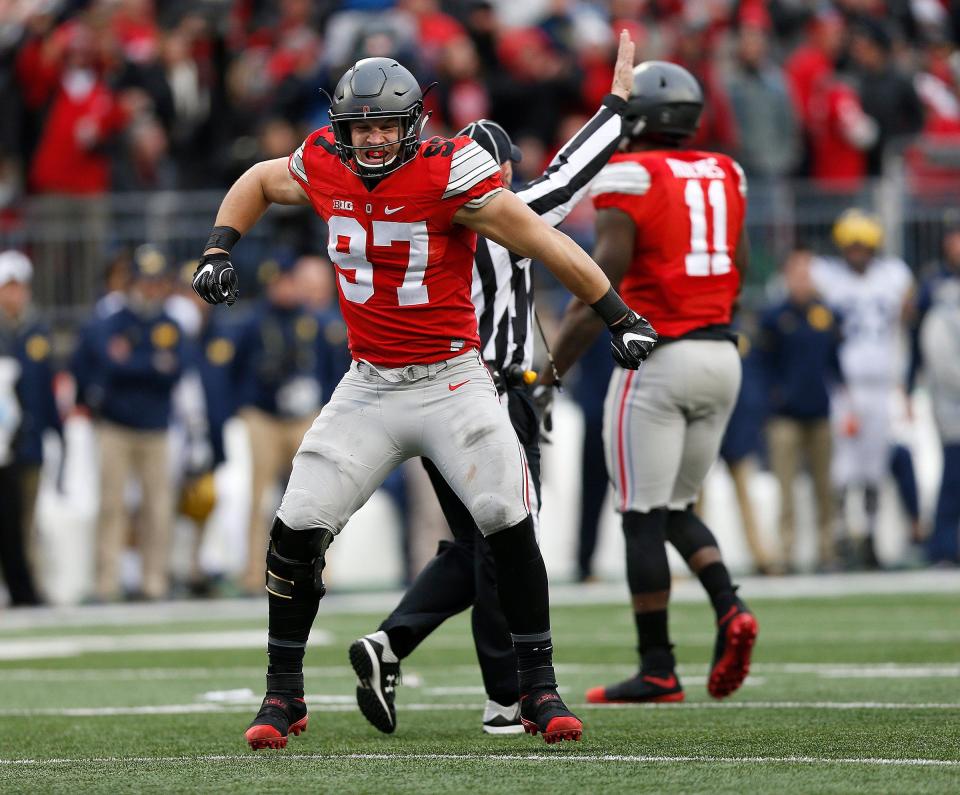 Ohio State Buckeyes defensive end Nick Bosa (97) celebrates his sack of Michigan Wolverines quarterback Wilton Speight (3) during the second half of the NCAA football game between the Ohio State Buckeyes and the Michigan Wolverines at Ohio Stadium on Saturday, November 26, 2016. (Columbus Dispatch photo by Jonathan Quilter) 