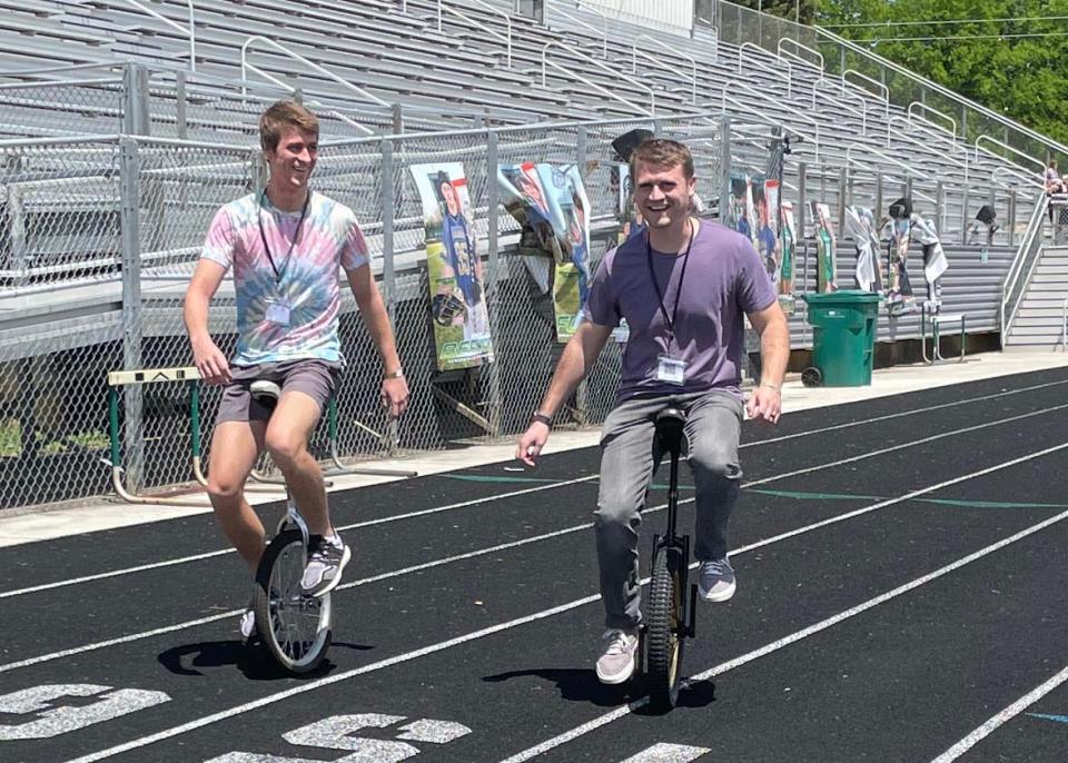 David Ridenour and his brother Roger make their way around the track doing tricks on unicycles at the Family Friendzy fundraiser at Knoxville Catholic High School Sunday, April 30, 2023.