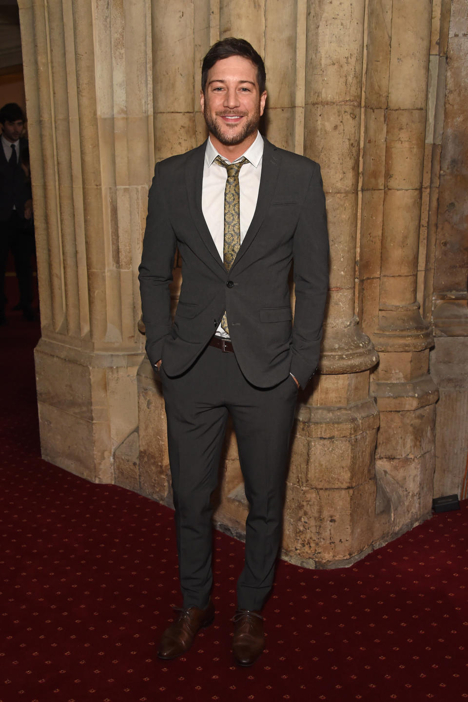 Matt Cardle smiles in a suit with his hands in his pockets as he attends The UK Theatre Awards 2018 at The Guildhall on October 14, 2018 in London