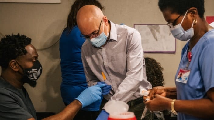 (From left) Texas pharmacist Gabriel Balonwu, Dr. Hossein Tcharmtchi and pharmacist Ngozi Anaduaka prepare COVID-19 vaccine doses at a clinic for 12- to 15-year olds in the center of West University. (Photo by Brandon Bell/Getty Images)