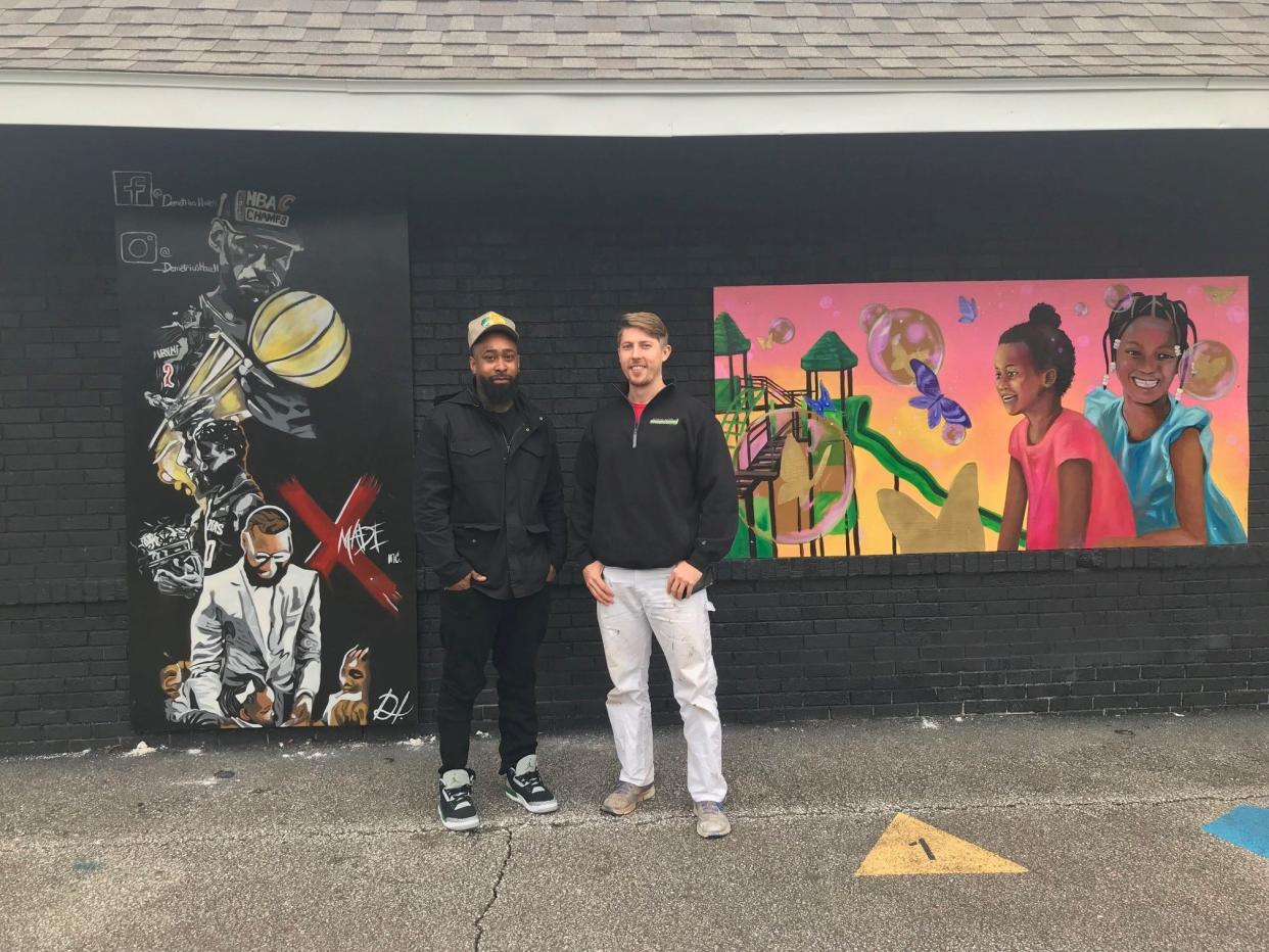 Demetrius Howell, at left, is the artist of the new mural at Johns Park depicting the many faces of Lebron James. Samantha Howell, not pictured, painted the mural at right. With Howell is Luke Beekman of Mankind Murals Inc.  A dedication is set for 2 p.m. Sunday at the pavilion at Johns Park. The public is invited.
