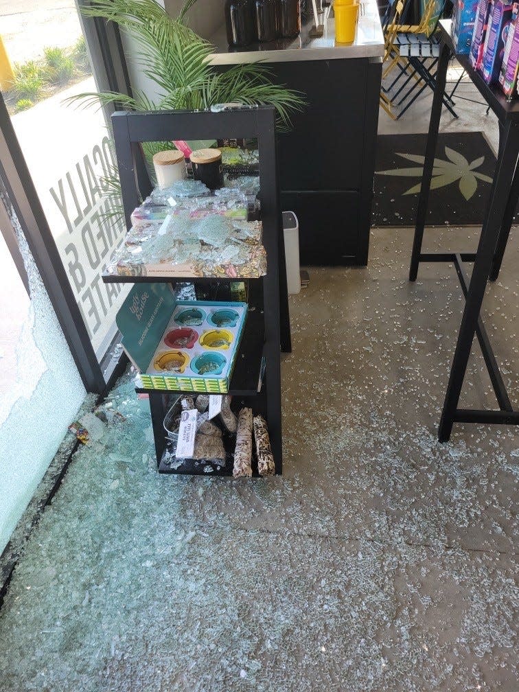 Shattered glass left at the scene of an early morning robbery at Tallulah Delta 8 + Floating on Wednesday, April 13, 2022.