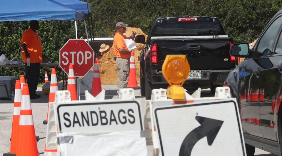 Residents pick up sandbags at the Nova Community Center in Ormond Beach on Monday.