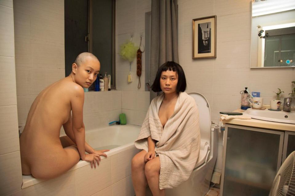 <strong>Aixiao Li</strong> — Winner: Portraits of Influence<span class="copyright">Title: Wig in the Bathroom (from the series “I Am with Me”); Caption: When the COVID-19 pandemic broke out in 2020, I was forced to stay at home for a long time. While everyone began to maintain social distance, I wanted to get in touch with people in reality. I started to explore the mostly unknown private spaces of strangers. We chatted and did everyday things together, and they lent me their clothes and accessories so I could ‘be them.’ A tacit understanding between my subjects and me was, ‘When I give you a sense of security you need to keep me safe.’ This kind of private connection involved exchanging so much personal information that we started to ‘become’ each other.</span>