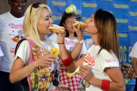 <p>Current women’s champion Miki Sudo, left, of Las Vegas, and challenger Michelle Lesco, of Tuscon, Ariz., feed each other a hot dog Monday, July 3, 2017, during the weigh-in for the 2017 Nathan’s Hot Dog Eating Contest, in Brooklyn Borough Hall, in New York. Ms. Suto weighed-in at 126 pounds, while Ms. Lesco tipped the scales at 104.5 pounds.(AP Photo/Richard Drew) </p>