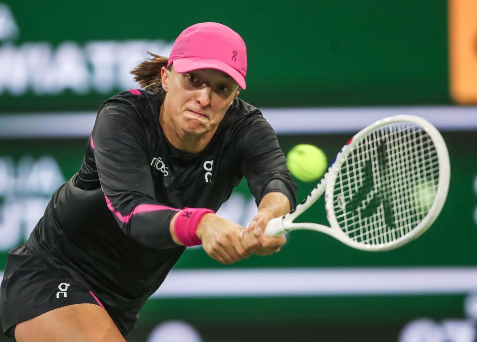 Iga Swiatek hits a shot in her win over Yulia Putintseva during the BNP Paribas Open in Indian Wells, Calif., March 12, 2024.