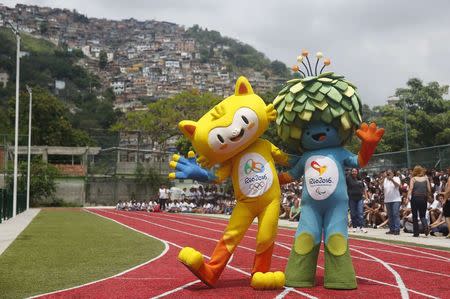 The unnamed mascots of the Rio 2016 Olympic (L) and Paralympic Games are pictured with the Morro dos Prazeres slum in the background during its presentation in Rio de Janeiro, November 24, 2014. REUTERS/Pilar Olivares