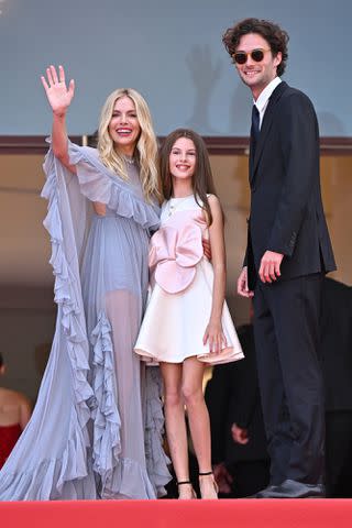 <p>Lionel Hahn/Getty</p> Sienna Miller with her daughter Marlowe and boyfriend Oli Green at the Cannes Film Festival