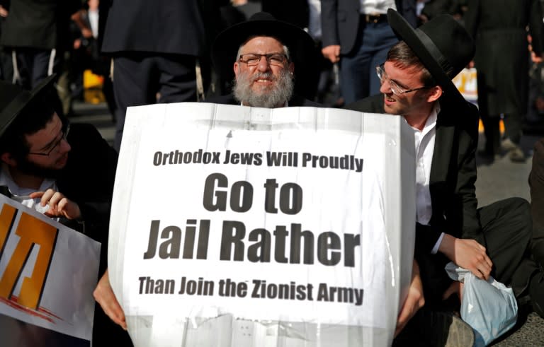 An Ultra-Orthodox Jewish demonstrator carries a sign during a protest against Israeli army conscription in Jerusalem on October 19, 2017