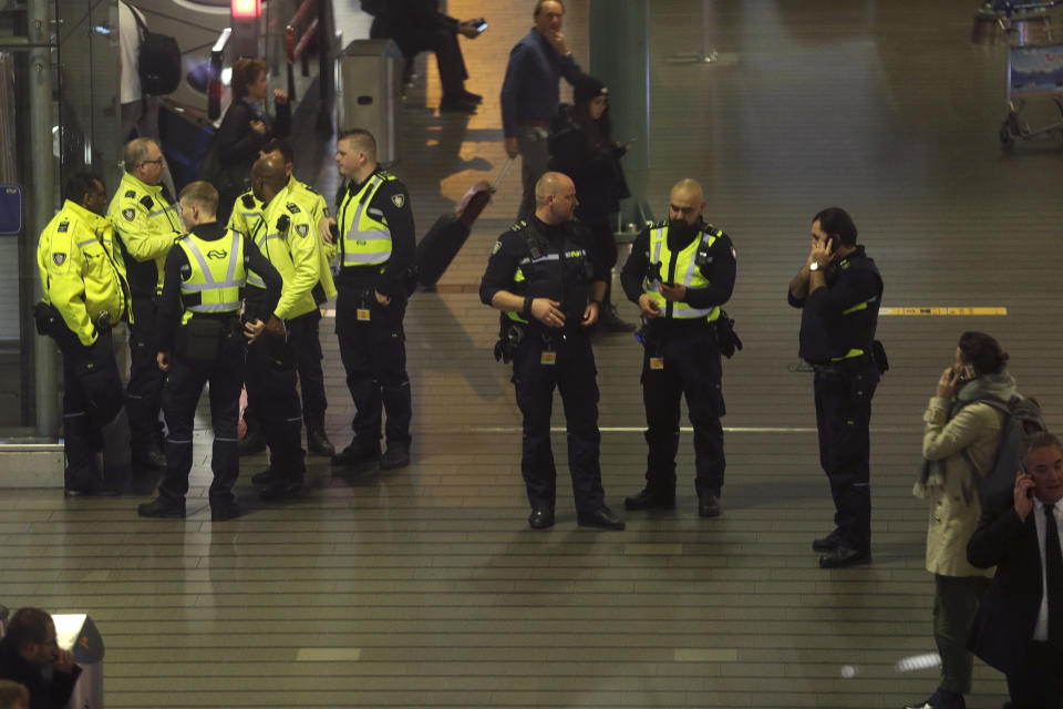 Dutch police mill about after a threat at Schiphol airport in Amsterdam, Netherlands, Wednesday, Nov. 6, 2019. Dutch military police say that all passengers and crew are safely off a plane at the center of a security alert at Amsterdam's Schiphol Airport. The military police service earlier said they were responding to a suspicious situation at the airport on the outskirts of Amsterdam. (AP Photo/Peter Dejong)