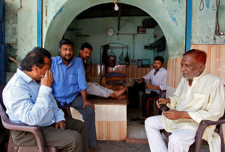 Meat vendors sit inside a shop in Allahabad, India March 28, 2017. REUTERS/Jitendra Prakash