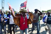 <p>Residents of Nyang’oma village in Kogelo wave US flags as they gather by the side of the road to wait for former US President, Barak Obama to arrive on July 16, 2018 for the opening of the Sauti Kuu Resource Centre, founded by his half-sister, Auma Obama at Kogelo in Siaya county, western Kenya. – Obama is in the East African nation for the first time since he left the US presidency and met with President Uhuru Kenyatta and opposition leader Raila Odinga in Nairobi. (Photo: Tony Karumba/AFP/Getty Images) </p>