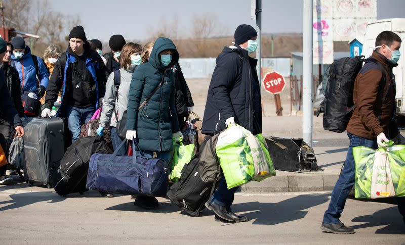 People queue to cross to Ukraine at the border crossing in Dorohusk