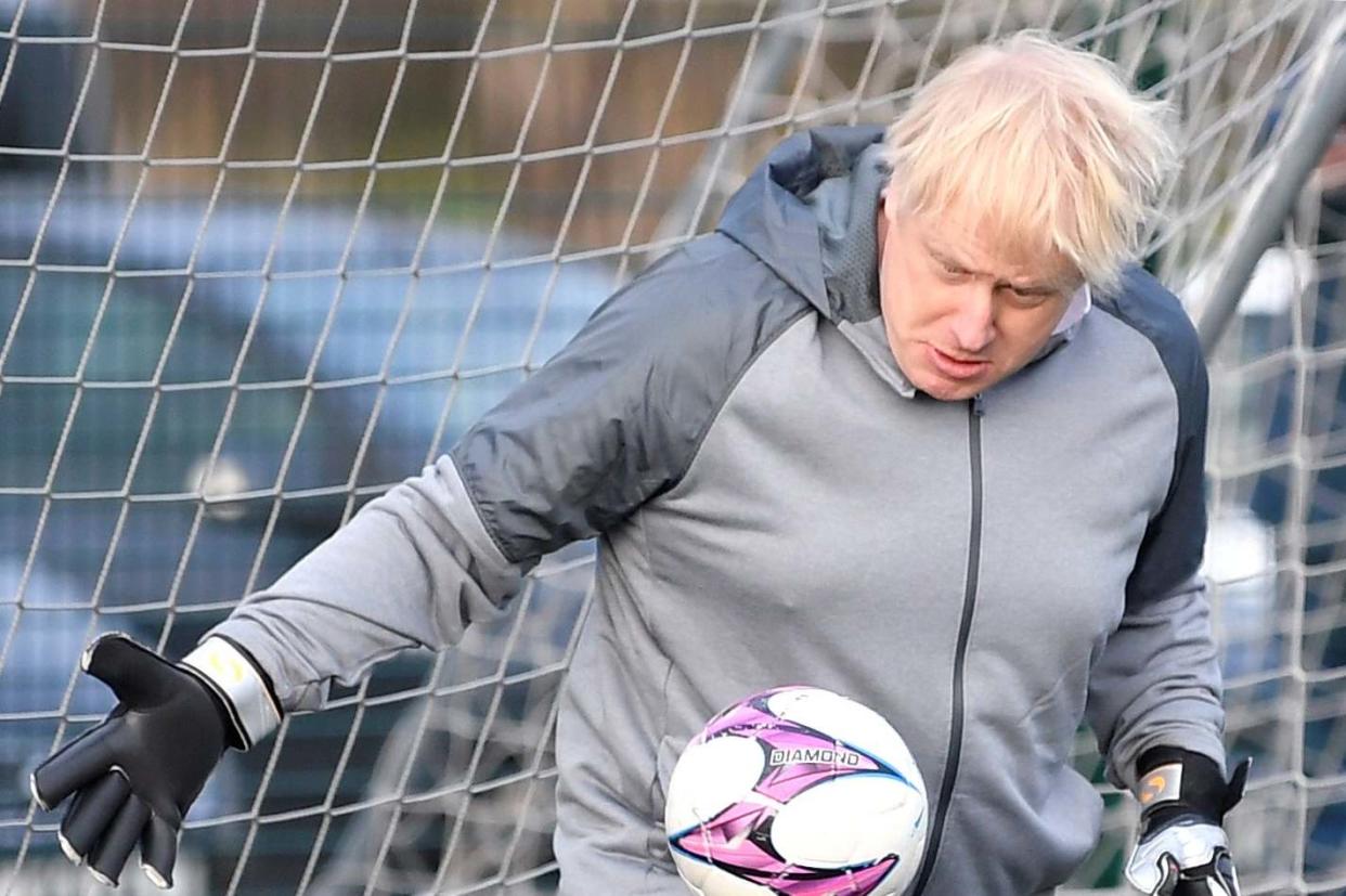 Boris Johnson takes a turn in goal during the warm up before a girls' soccer match: Getty