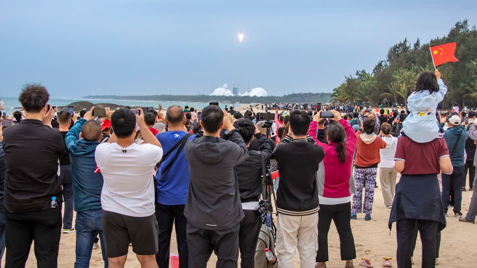 Spectators gathered on a beach in Wenchang to watch the Long March-8 Y3 carrier take off in March 2024. (Photo by Liu Guoxing/VCG via Getty Images) - Liu Guoxing/VCG/Getty Images