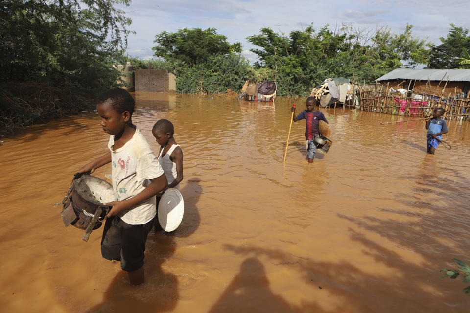 Children fleeing floodwaters that wreaked havoc at Mororo, border of Tana River and Garissa counties, North Eastern Kenya, Sunday, April 28, 2024. The East African country has seen weeks of heavy rains and severe flooding in Kenya’s capital, Nairobi, as well as in the country's western and central regions. (AP Photo/Andrew Kasuku)