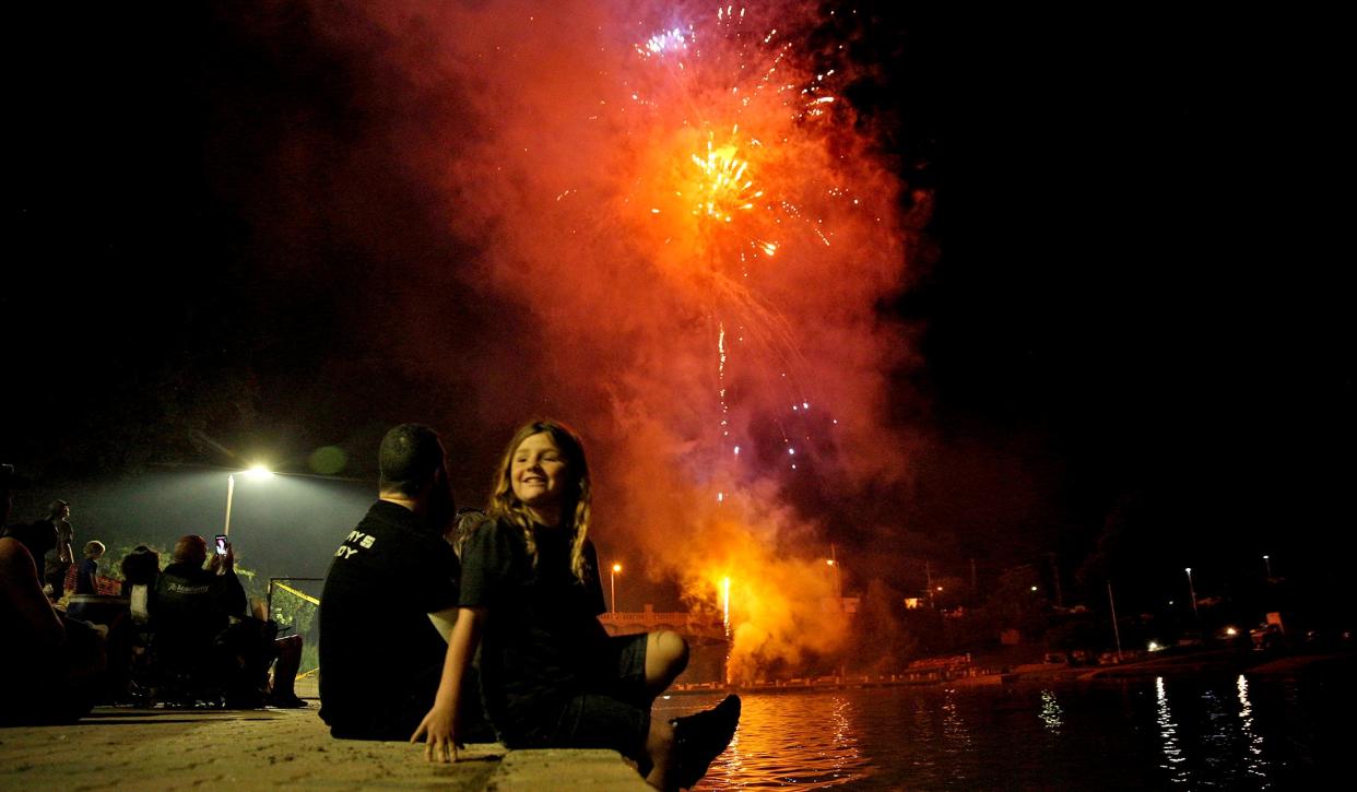 People gather along the Concho River to watch fireworks during the Star Spangled Concert and Fireworks event Saturday, July 3, 2021.