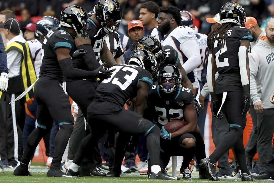 Jacksonville Jaguars cornerback Tyson Campbell (32) celebrates catching the ball during the NFL football game between Denver Broncos and Jacksonville Jaguars at Wembley Stadium in London, Sunday, Oct. 30, 2022. (AP Photo/Ian Walton)