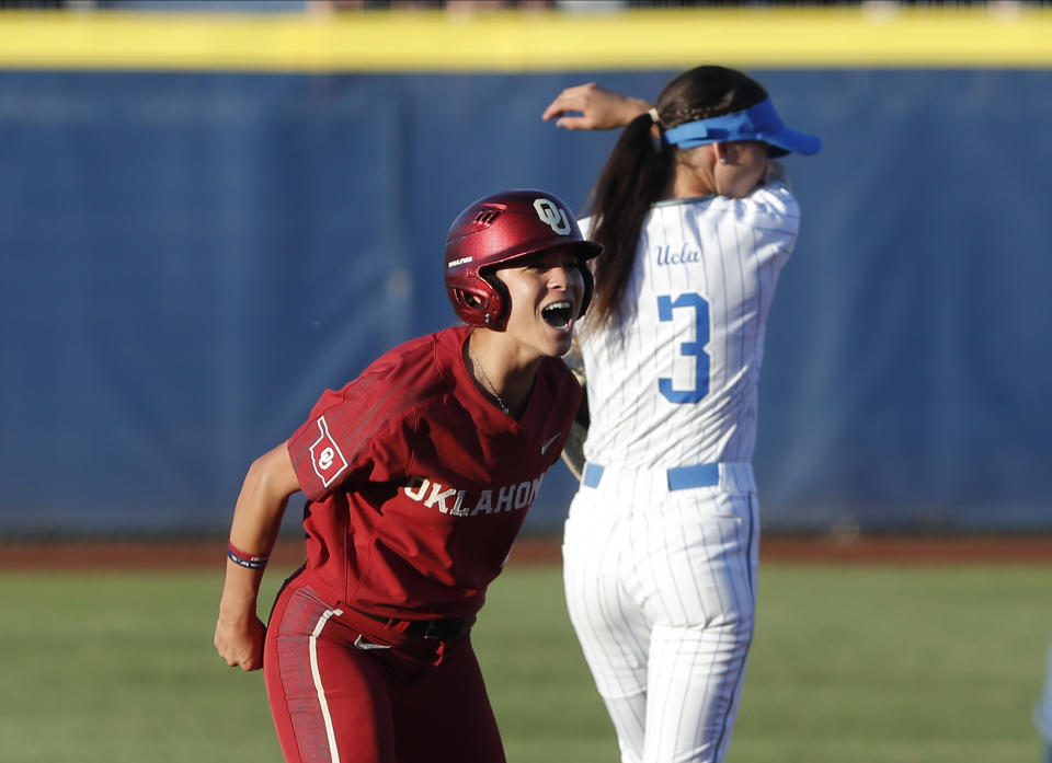 Oklahoma's Sydney Romero gestures after making it to second base against UCLA during the first inning of Game 2 of the best-of-three championship series in the NCAA softball Women's College World Series in Oklahoma City, Tuesday, June 4, 2019. (AP Photo/Alonzo Adams)