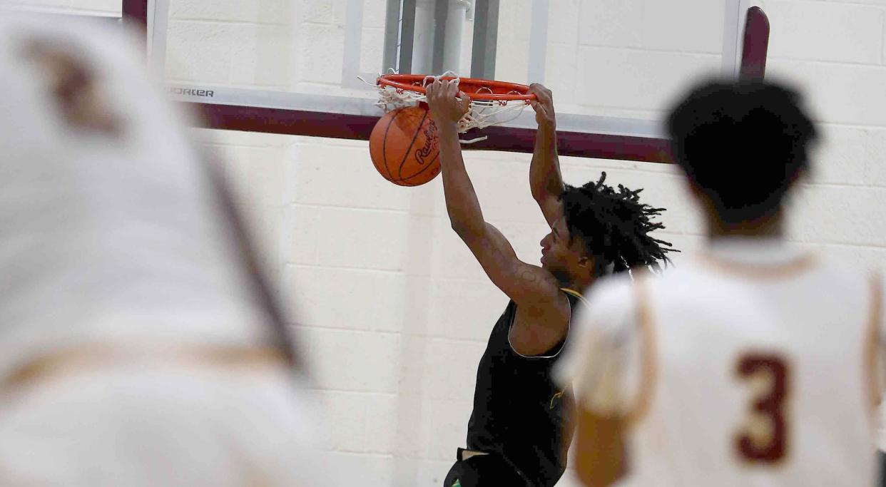 Taft's Rayvon Griffith dunks during their basketball game against Western Hills, Friday, Dec. 17, 2021.