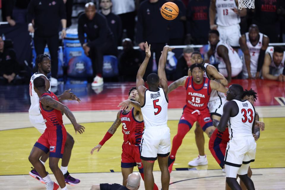 Apr 1, 2023; Houston, TX, USA; San Diego State Aztecs guard Lamont Butler (5) shoots the game winning basket over Florida Atlantic Owls guard Nicholas Boyd (2) during the second half in the semifinals of the Final Four of the 2023 NCAA Tournament at NRG Stadium. Mandatory Credit: Troy Taormina-USA TODAY Sports