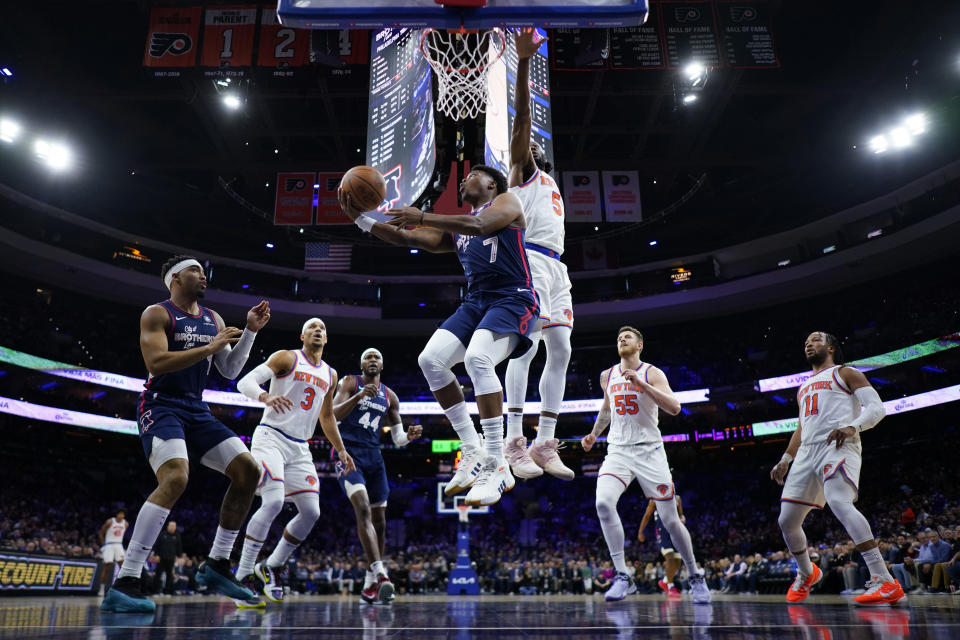Philadelphia 76ers' Kyle Lowry (7) goes up for a shot against New York Knicks' Precious Achiuwa (5) during the first half of an NBA basketball game, Thursday, Feb. 22, 2024, in Philadelphia. (AP Photo/Matt Slocum)