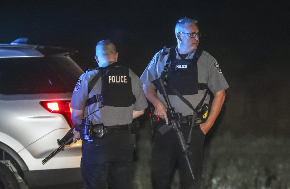 Villa Rica police block Highway 61 at East Bay Springs Drive after three metro Atlanta officers were injured Monday, April 12, 2021, after a police chase entered Carroll County, Ga., and a passenger fired multiple rounds with a rifle, officials said. Georgia authorities said one suspect was killed and the other arrested following the chase. (John Spink/Atlanta Journal-Constitution via AP)