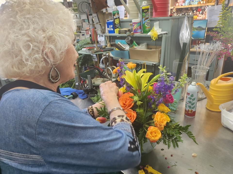 Mary Ruth Albracht, owner of Scott's Flowers, prepares finishing touches on bouquet in preparation for Mother's Day as orders begin to flood in.