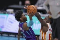 Charlotte Hornets forward Jalen McDaniels, left, drives to the basket against Atlanta Hawks center Clint Capela, right, during the third quarter of an NBA basketball game in Charlotte, N.C., Sunday, April 11, 2021. (AP Photo/Nell Redmond)