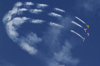 <p>Pilots of the British aircraft aerobatics team Global Stars show their flying skills during the inauguration of three-day air show in Ahmedabad, India, on April 29, 2016. The three-day air show was the part of the Gujarat state Foundation Day celebrations. <i>(Ajit Solanki/AP)</i><br></p>