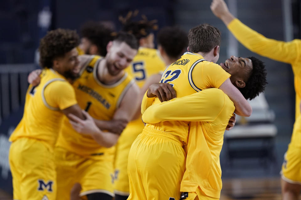 The Michigan bench reacts after winning the Big Ten title against Michigan State in the second half of an NCAA college basketball game, Thursday, March 4, 2021, in Ann Arbor, Mich. (AP Photo/Carlos Osorio)