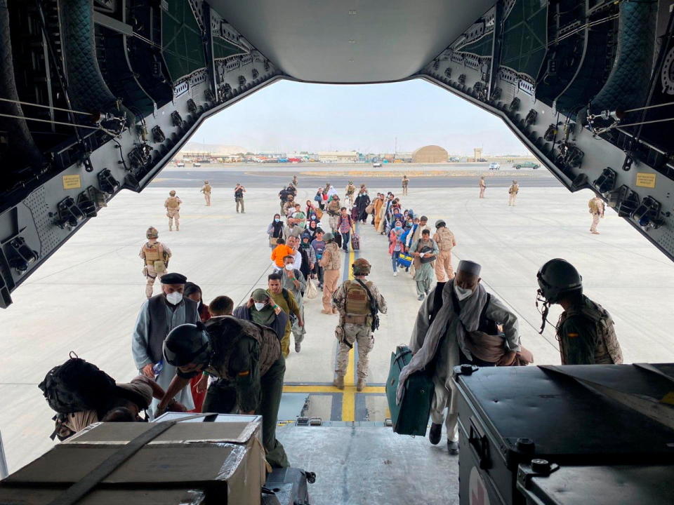 Afghans and Spanish citizens residing in Afghanistan board a military plane as part of their evacuation, at the Hamid Karzai International Airport in Kabul, Afghanistan, August 18, 2021. (Ministry of Defense of Spain/Handout via Reuters)