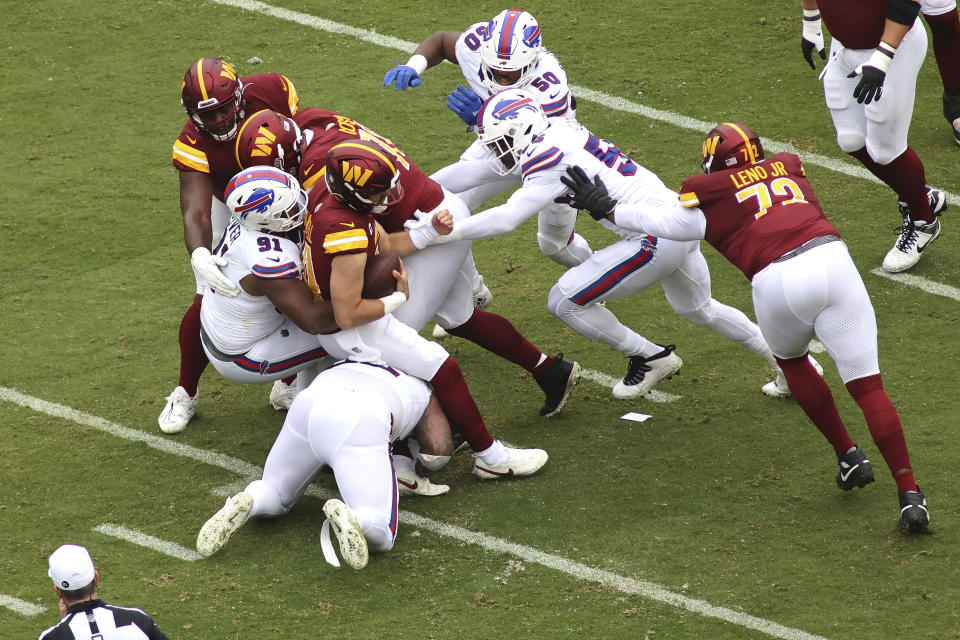 Washington Commanders quarterback Sam Howell (14) gets sacked during an NFL football game against the Buffalo Bills, Sunday, September 24, 2023 in Landover, Maryland. (AP Photo/Daniel Kucin Jr.)