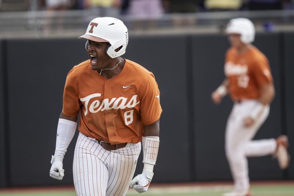 Texas' Dylan Campbell celebrates after hitting a walkoff single off East Carolina's Wyatt Lunsford-Shenkman during the ninth inning of an NCAA college super regional baseball game on Saturday, June 11, 2022, in Greenville, N.C. (AP Photo/Matt Kelley)