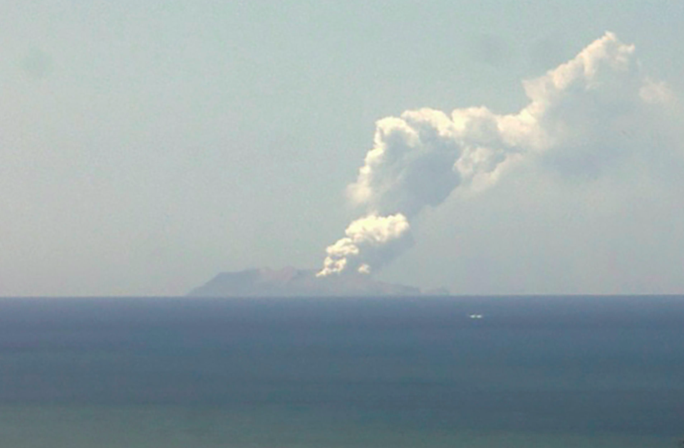 A plume of smoke rises from the volcano on White Island (Picture: AP)