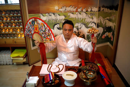 Jang Yong-jun, a traditional shaman, performs at his home in Seoul, South Korea, September 13, 2017. Picture taken on September 13, 2017. REUTERS/Kim Hong-Ji