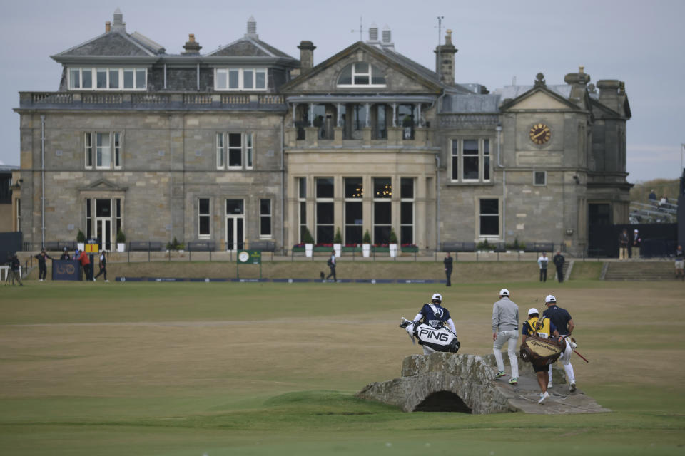 Rory McIlroy of Northern Ireland and Viktor Hovland, of Norway, right, cross the Swilken bridge on the 18th hole during the third round of the British Open golf championship on the Old Course at St. Andrews, Scotland, Saturday July 16, 2022. (AP Photo/Peter Morrison)